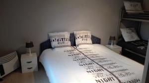 a bedroom with a bed with white sheets and pillows at Aux doux rêves in Provèdroux