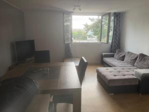 a living room with a couch and a table at Location chambre verte dans un appartement en colocation in Nevers