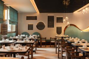 a dining room with tables and chairs at Moon & Sun Funchal in Funchal