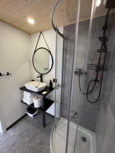a bathroom with a shower and a sink at Domek nad plażą in Chańcza