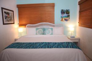 a bedroom with a large white bed with two lamps at Point Pleasant Resort® 1BR Suite with Ocean Views in Nazareth