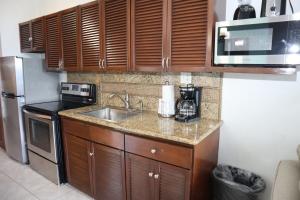 a small kitchen with a sink and a microwave at Point Pleasant Resort® 1BR Suite with Ocean Views in Nazareth