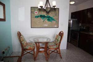 a dining room table and two chairs in a kitchen at Point Pleasant Resort® 1BR Suite with Ocean Views in Nazareth +5 photos