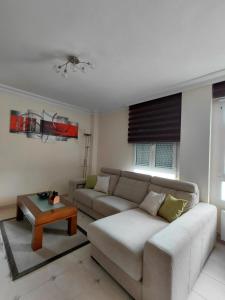 a living room with a couch and a coffee table at Tejas verdes in Argoños
