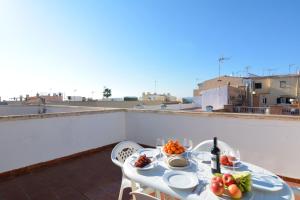 a table with a plate of food on a roof at 28 Townhouse 200mts from sea/beach in Palma de Mallorca