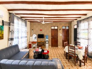 a living room with a couch and a table at Simba Apartments in Diani Beach