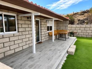 a patio of a house with a table and a bench at Finca Domingo in Fasnia +12 photos