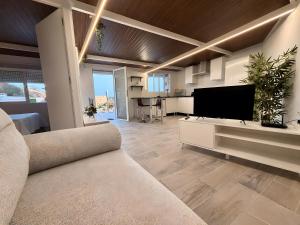 a living room with a couch and a flat screen tv at Finca Domingo in Fasnia