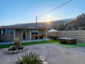a house with a backyard with a table and a patio at Finca Domingo in Fasnia