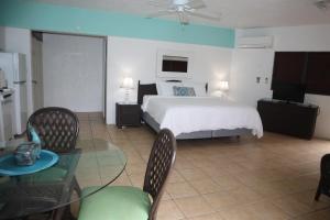 a bedroom with a bed and a table and chairs at Point Pleasant Resort® 1BR Suite with Ocean Views in Nazareth