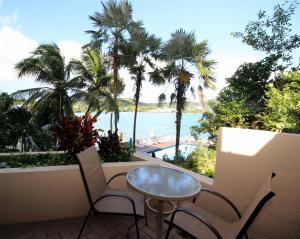 a patio with a table and chairs and a view of the ocean at Point Pleasant Resort® 1BR Suite with Ocean Views in Nazareth