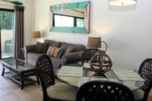 a living room with a couch and a table and chairs at Point Pleasant Resort® 1BR Suite with Ocean Views in Nazareth