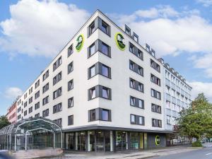 a white building with a sign on the side of it at B&B Hotel Nürnberg-City in Nuremberg
