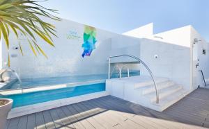 a swimming pool with stairs and a swimming pool at Hotel White Lisboa in Lisbon