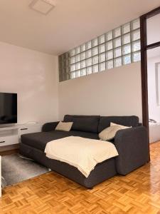 a living room with a bed and a couch at Apartman Centar, Modrica in Modriča