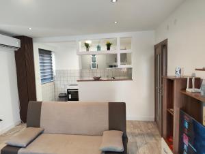 a living room with a couch and a kitchen at Kravica Oasis in Ljubuški