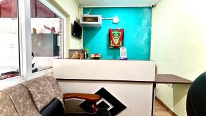 a living room with a couch and a blue wall at Hotel Hill Edge in Kodaikānāl +56 photos