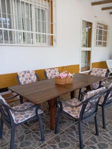 a wooden table with chairs and a basket on it at Casa La Vega in Torrox Costa