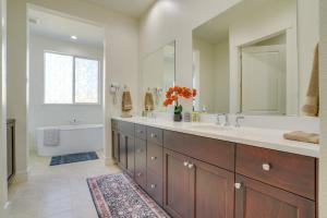 a bathroom with a sink and a bath tub and a mirror at Private Yard & Patio! Modern Manteca Gem in Manteca +21 photos