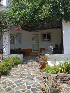 a garden with a stone walkway in front of a building at Casa La Vega in Torrox Costa