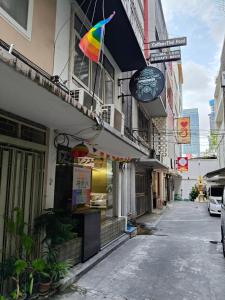 a building with a rainbow flag on a street at Dreamcatcher Bangkok in Bangkok
