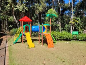 a playground in a park with a slide at Vista Azul Hotel Frente Pedra Azul in Pedra Azul