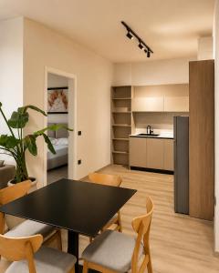a kitchen and dining room with a table and chairs at Emera Apartments in Vlorë