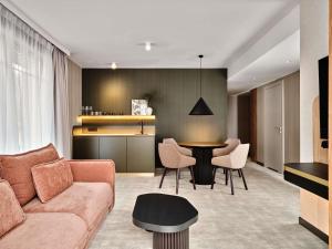 a living room with a couch and a table at Mövenpick Resort & Spa Karpacz in Karpacz