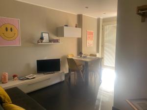 a living room with a table with a computer on it at La Casa di PAT in Campobasso