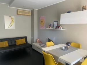 a dining room with a table and yellow chairs at La Casa di PAT in Campobasso