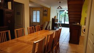 a dining room with a wooden table and chairs at Domaine de Beaudon Les Coucous in Augerville-la-Rivière