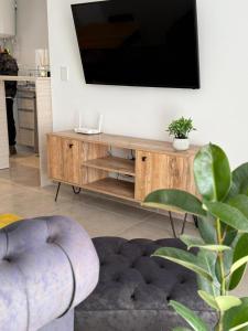 a living room with a flat screen tv on the wall at luxury apart 1 in Villa María