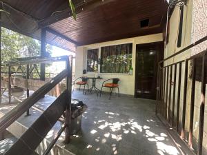 a porch of a house with a table and chairs at Къща за гости Амбър in Burgas