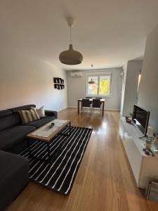 a living room with a couch and a table at Apartman Vila&Vera in Sremska Mitrovica