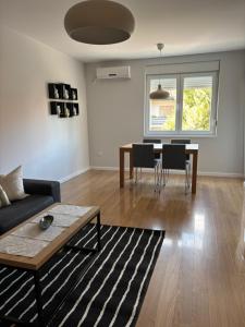 a living room with a couch and a table at Apartman Vila&Vera in Sremska Mitrovica