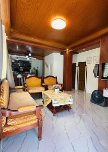 a living room with couches and a table at LALEAH Transient House in Cotabato