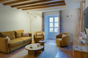 a living room with a couch and chairs and a table at Le Domaine de Falgos Golf & Spa in Saint-Laurent-de-Cerdans