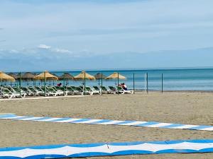 a beach with chairs and umbrellas and the ocean at Apartamento El Mar Azul 5 in Torremolinos +25 photos