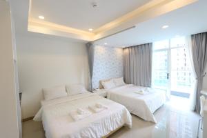 Postel nebo postele na pokoji v ubytování CA&SA Serviced Apartment