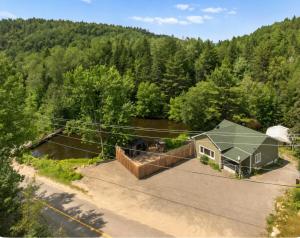 an overhead view of a house in the woods at Chalet avec spa et lac privé in Saint Come