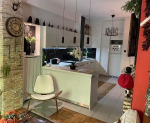 a kitchen with a counter and a chair in a room at Avant-Garde Studio in Athens