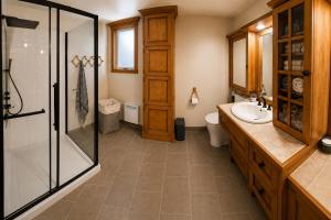 a bathroom with a glass shower and a sink at Chalet avec spa et lac privé in Saint Come +16 photos