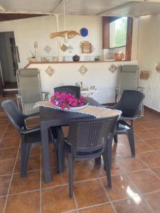 a dining room table and chairs with flowers on it at Villamare in Custonaci