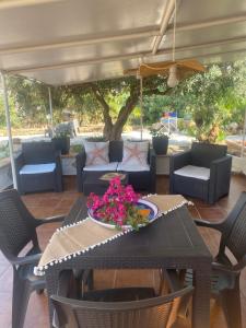 a table with a bowl of flowers on a patio at Villamare in Custonaci