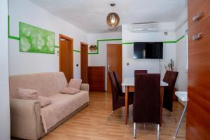 a living room with a couch and a table at Villa Best Relax in Okrug Donji