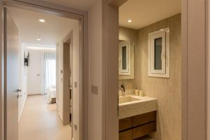 a bathroom with a sink and a mirror at ΛΑΚΩΝΙΖΕΙΝ Luxury Suites in Sparta +52 photos
