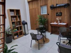 a room with chairs and a table and a desk at Au bât Tournai chambre Bohème in Tournai +4 photos