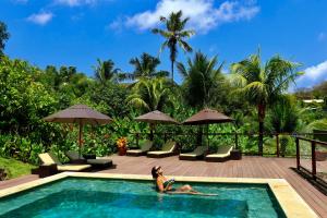 a woman laying in the pool at a resort at Pousada do Vale in Fernando de Noronha