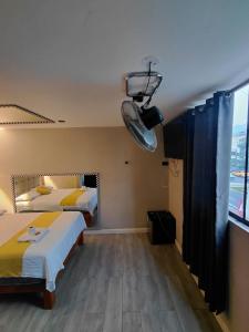 a hotel room with two beds and a chandelier at URBAN suites in Lima