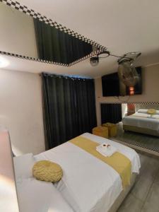 a bedroom with a bed with a yellow and white blanket at URBAN suites in Lima